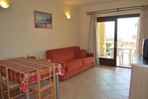 a living room with a couch and a table at Appartamenti Golfo Aranci in Golfo Aranci