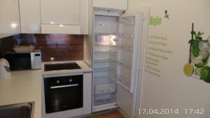 a kitchen with an oven and an open refrigerator at Apartment Trnje in Zagreb +59 photos