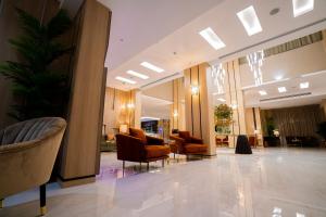 a lobby with couches and chairs in a building at فندق فايف سيزون in Al Khobar