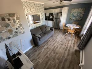 a living room with a couch and a table at The Pines Motel and Cottages in Rustico