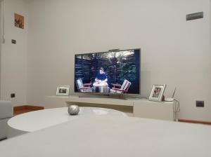 a living room with a flat screen tv on a wall at APARTMAN SIMIC - STAN NA DAN in Bogatić