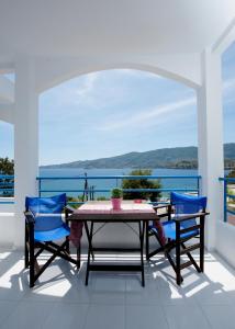 a dining room table with a blue and white tablecloth at Christine Studios in Poros
