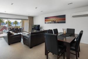 a living room with a table and a dining room at Luxury Waterfront Apartment - Abode No 1 in Picton