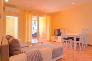 a living room with a couch and a table at Apartments Tare, Electric Car Refill in Vodice