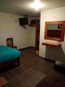a living room with a couch and a sink at Hotel Tlatoani in Chignahuapan