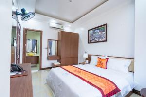 a bedroom with a bed and a telephone in it at Đinh Gia Hotel in Ha Giang