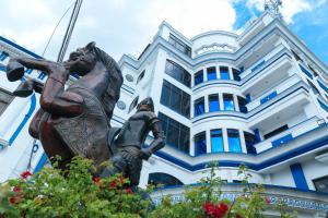 a bronze statue in front of a building at RedDoorz Plus @ Castle Chateau Iloilo in Iloilo City