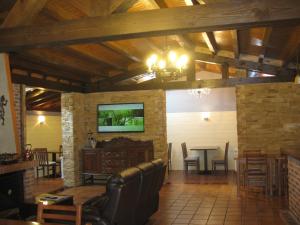 a living room with a table and a dining room at Hotel Rural Entremontes in Cangas de Onís