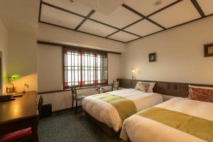 Tempat tidur dalam kamar di Hotel Aru Kyoto Sanjo Kiyamachi Do-ri