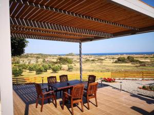a table and chairs on a patio with a view at Villa Dimitrios in Kiotari