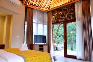 Vuode tai vuoteita majoituspaikassa Kenran Resort Ubud By Soscomma