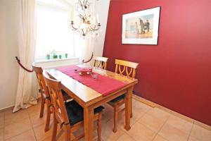 a dining room with a wooden table and chairs at Residenz-Ostseestrand-Wohnung-30-337 in Kühlungsborn