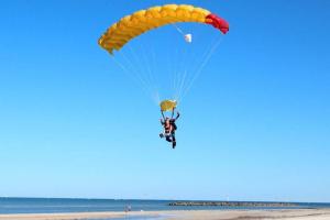 a person flying a parachute on the beach at Lovely Modern 3br 2bth Beachside suburb Home in Largs