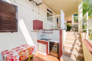 a small kitchen with a sink and a stove at Apartments Rašica Molunat in Molunat