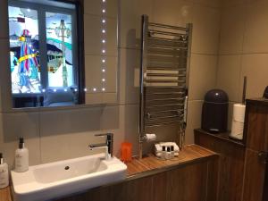 a bathroom with a sink and a mirror at Guest And The City in Brighton & Hove
