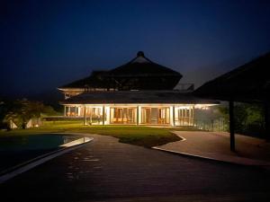 a large house with a lit up building at night at MOUNTAIN SHADOWS RESORTS in Wayanad