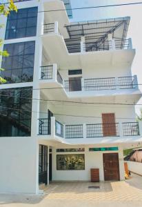 a white building with balconies on the side of it at Zcube Andaman in Port Blair