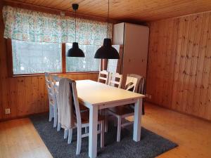a dining room table and chairs in a room at Sjöstuga Vätö in Harg