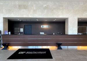 a lobby with a reception desk in a building at Blue Port Hotel Kitakyushu Airport in Kanda
