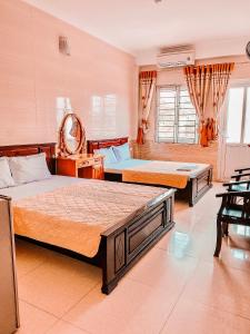 a bedroom with two beds in a room at Thien Nhan Hotel in Cửa Lò