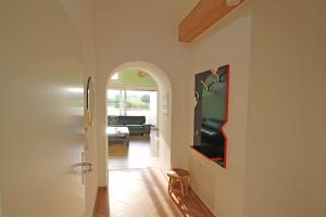 a hallway with a living room with a television at Buesumer-Ring-Strandmuschel-501 in Kühlungsborn