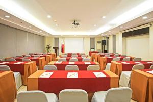 a room with rows of tables and chairs at Alpa City Suites Hotel in Cebu City