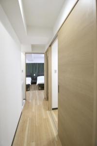 a hallway of a hotel room with a door leading to a bedroom at Uhome千駄木静雅民宿旅馆 in Tokyo