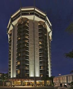 a tall building with lights on it at night at Hotel Angeleno in Los Angeles