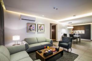 a living room with two couches and a dining room at Boudl Al Wadi in Riyadh
