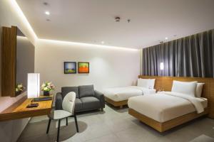 a hotel room with two beds and a couch at Boudl Al Wadi in Riyadh +33 photos