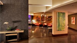 a lobby with a living room and a dining room at Hotel Angeleno in Los Angeles