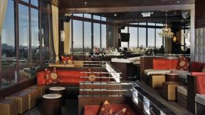 a room with a bar with a lot of windows at Hotel Angeleno in Los Angeles