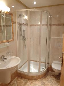 a bathroom with a shower and a sink at Berghotel Türlwand in Ramsau am Dachstein
