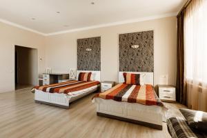 a bedroom with two beds in a room at Sport Hotel Maximum in Kemerovo