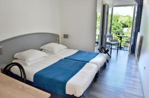 a bedroom with a large bed with a blue blanket at Domaine de Lacave in Lacave +17 photos