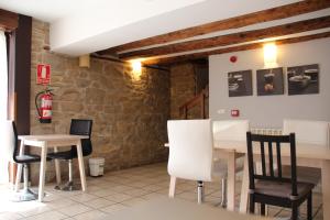 a room with two tables and chairs and a fire hydrant at Hospedaje Nuestra Señora de Ujue in Tafalla