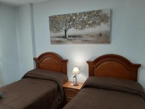 Postel nebo postele na pokoji v ubytování ALOJAMIENTO LA TERRAZA DE LUIS