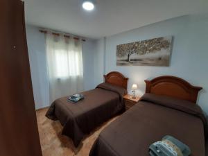 Postel nebo postele na pokoji v ubytování ALOJAMIENTO LA TERRAZA DE LUIS