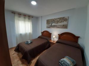 Postel nebo postele na pokoji v ubytování ALOJAMIENTO LA TERRAZA DE LUIS