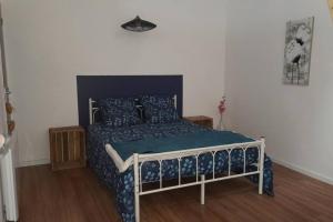 sypialnia z łóżkiem z niebieską kołdrą w obiekcie Gîte Appartement 2 chambres La maison en brique avec rivière w mieście Aumale