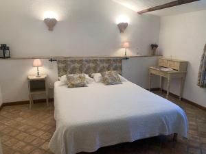 ein Schlafzimmer mit einem großen weißen Bett und zwei Lampen in der Unterkunft Bastide Sainte Agnès in Carpentras