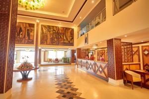 a lobby of a building with paintings on the walls at Goma Serena Hotel in Goma