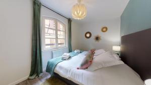 En eller flere senge i et værelse på Appartement 2 chambres La Commanderie