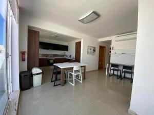 a kitchen and dining room with a table and chairs at High Street Apartments in Sliema