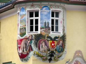 a painting on the side of a building with a window at Hotel Dolomiti Schloss in Canazei