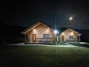 a log cabin at night with a light on it at KaliMera in Solina