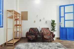 a living room with two chairs and a ladder at Cube homestay Phan Rang cách biển 300m to the beach in Phan Rang