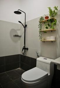 a bathroom with a toilet and a shower with plants at Cube homestay Phan Rang cách biển 300m to the beach in Phan Rang +37 photos