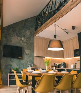 a dining room with a table and chairs at Apartamenty Pod Stokiem 200 m do kolejki Na Skrzyczne - Dream Apart in Szczyrk