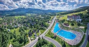 an aerial view of a resort with a pool at TatryTOP Apartamenty Kaszelewski in Zakopane